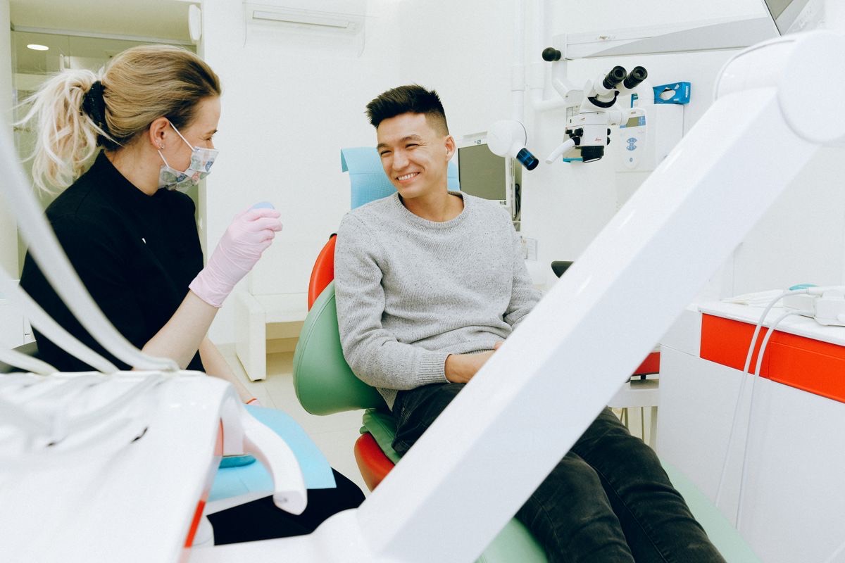 Dentist and patient smiling during a comfortable dental visit