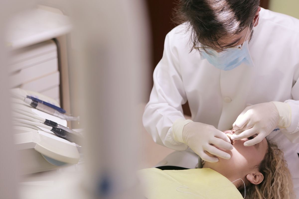Dentist performing oral treatment during implant care